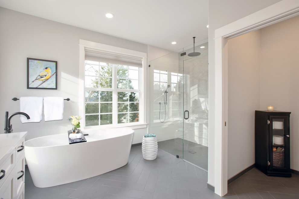 Photo of a medium sized contemporary ensuite bathroom in Portland with shaker cabinets, white cabinets, a freestanding bath, a built-in shower, ceramic tiles, grey walls, a submerged sink, quartz worktops and white worktops.