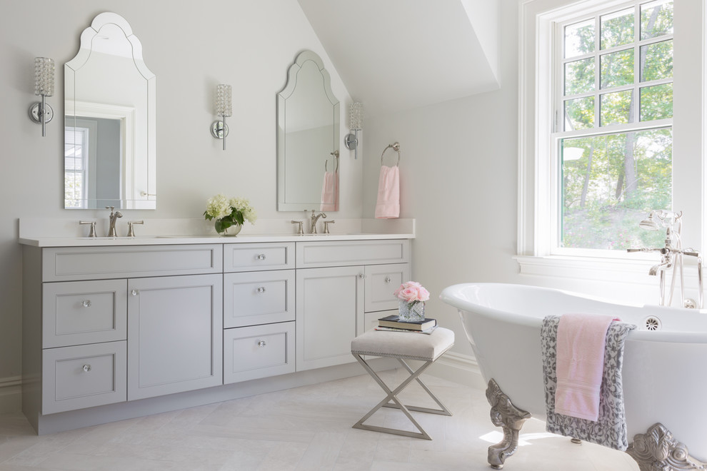 Inspiration for a large classic ensuite bathroom in Boston with recessed-panel cabinets, grey cabinets, a claw-foot bath, an alcove shower, white walls, porcelain flooring, a submerged sink, engineered stone worktops, grey floors, a hinged door and white worktops.