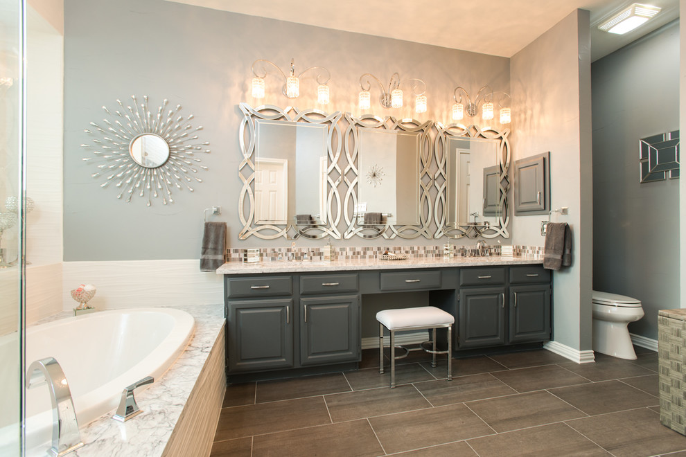 Trendy drop-in bathtub photo in Dallas with gray cabinets, marble countertops and gray countertops