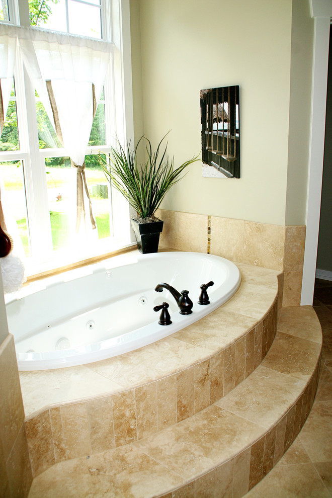 Drop-in bathtub - traditional beige tile drop-in bathtub idea in Grand Rapids
