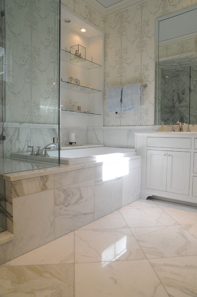 This is an example of a medium sized classic ensuite bathroom in Nashville with recessed-panel cabinets, white cabinets, a corner bath, a corner shower, a two-piece toilet, white tiles, marble tiles, white walls, marble flooring, a submerged sink, marble worktops, white floors and a hinged door.