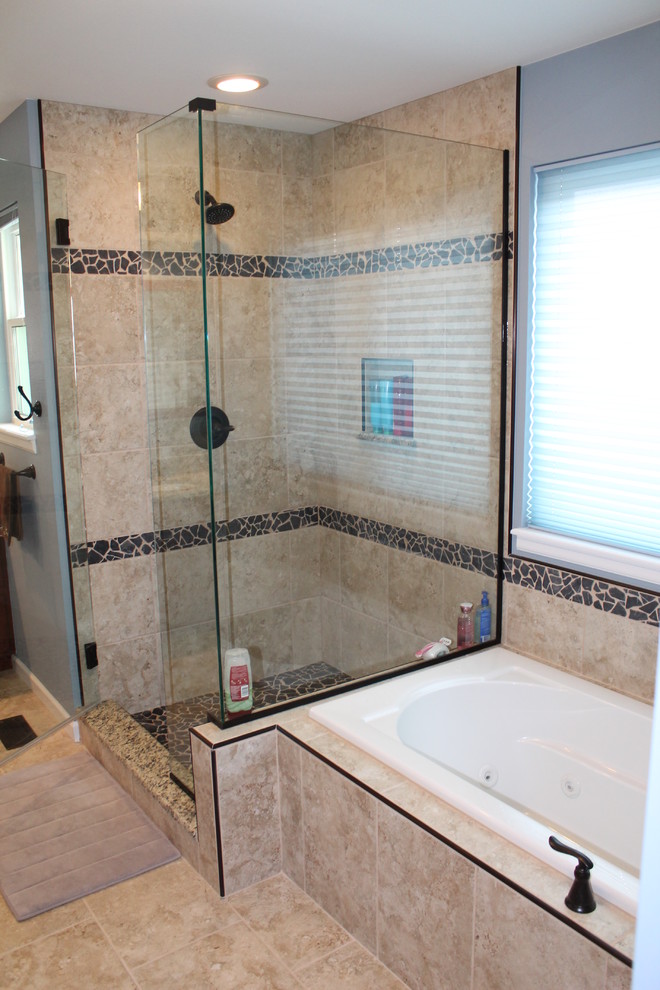 Elegant beige tile and porcelain tile bathroom photo in Denver with an undermount sink, raised-panel cabinets, medium tone wood cabinets, granite countertops and a two-piece toilet