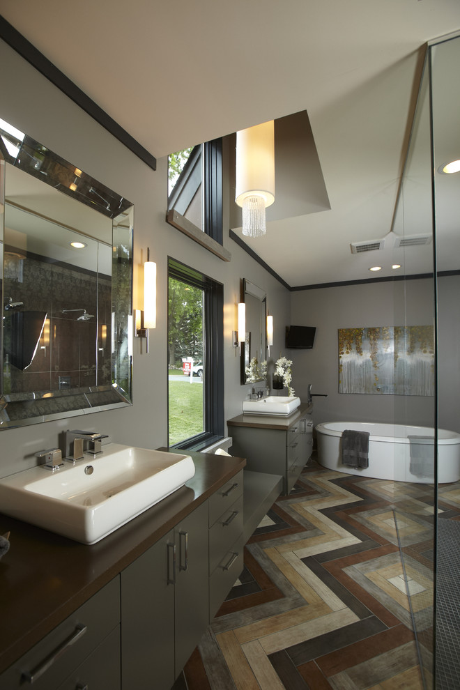 Freestanding bathtub - contemporary freestanding bathtub idea in Minneapolis with a vessel sink