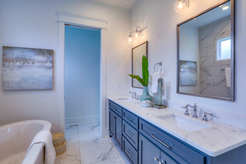 Large arts and crafts master white tile and marble tile marble floor and white floor bathroom photo in Nashville with flat-panel cabinets, blue cabinets, white walls, an undermount sink, quartz countertops, a hinged shower door and white countertops
