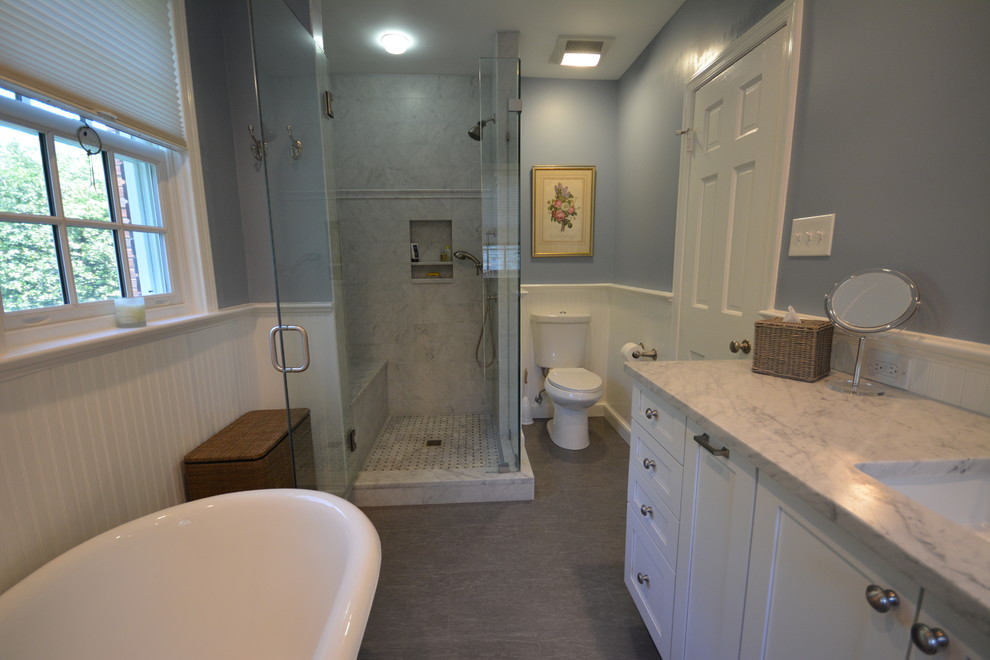 Example of a mid-sized minimalist master white tile and stone slab ceramic tile bathroom design in DC Metro with an undermount sink, raised-panel cabinets, white cabinets, marble countertops, a two-piece toilet and gray walls