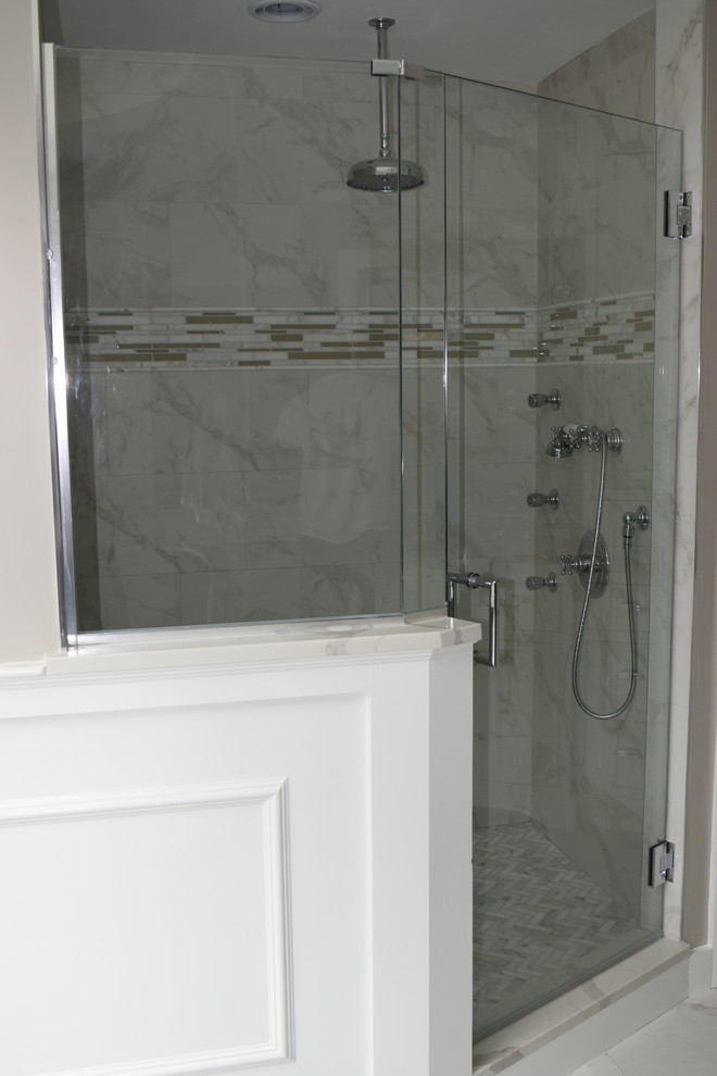 Example of a large classic master gray tile and porcelain tile marble floor and gray floor freestanding bathtub design in Boston with a hinged shower door and brown walls