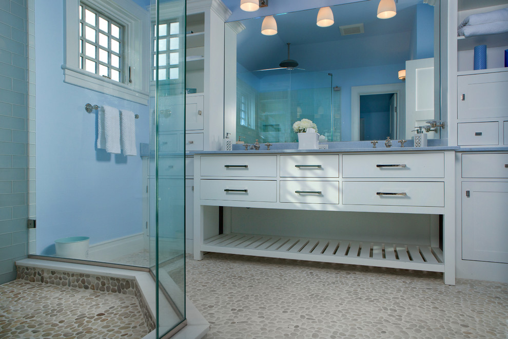 Mid-sized trendy master blue tile, green tile and glass tile pebble tile floor and beige floor corner shower photo in Portland Maine with beaded inset cabinets, white cabinets, blue walls and a hinged shower door