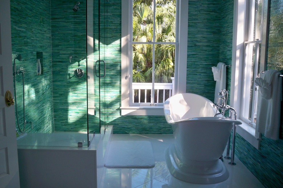 Large world-inspired ensuite bathroom in Miami with a freestanding bath, an alcove shower, blue tiles, green tiles, glass tiles, green walls and porcelain flooring.