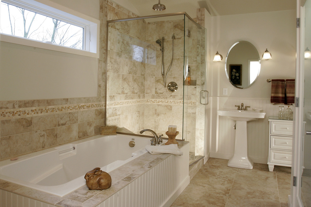 Photo of a classic bathroom in Portland with a pedestal sink, white cabinets, a built-in bath, a corner shower and beige tiles.