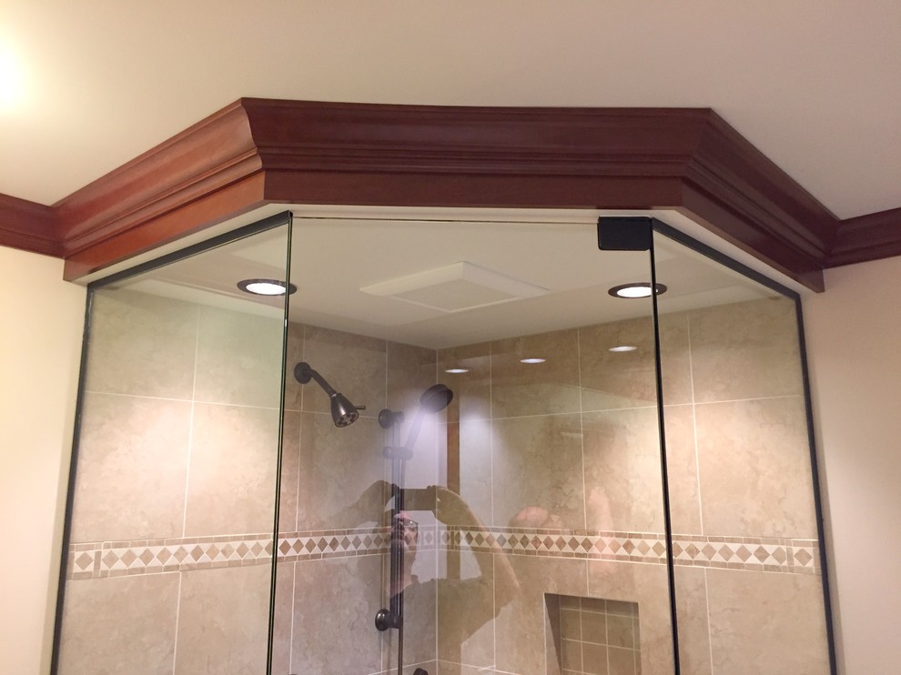 Example of a small classic master beige tile and porcelain tile porcelain tile corner shower design in Philadelphia with raised-panel cabinets, dark wood cabinets, a two-piece toilet, beige walls, an undermount sink and granite countertops