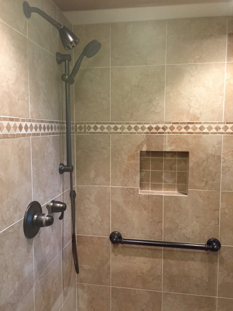 Small classic ensuite bathroom in Philadelphia with raised-panel cabinets, dark wood cabinets, a corner shower, a two-piece toilet, beige tiles, porcelain tiles, beige walls, porcelain flooring, a submerged sink and granite worktops.