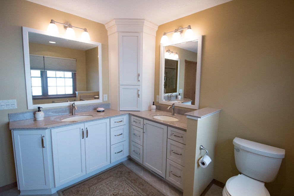 Traditional ensuite bathroom in Other with an integrated sink, shaker cabinets, solid surface worktops, a built-in shower, a two-piece toilet, beige tiles, ceramic tiles, yellow walls and ceramic flooring.