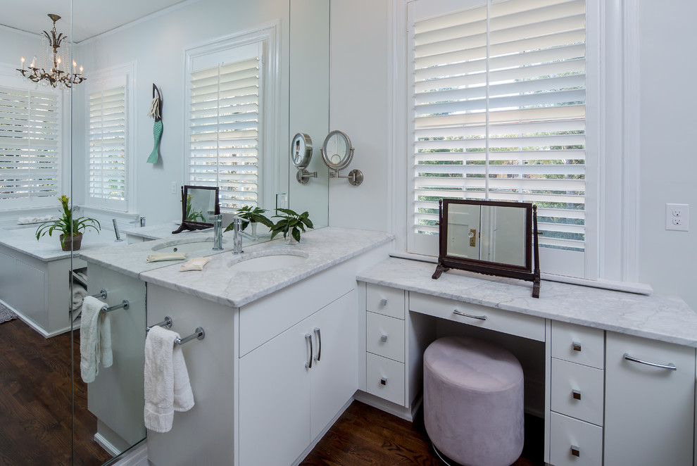 Photo of a large classic ensuite wet room bathroom in Atlanta with flat-panel cabinets, white cabinets, a corner bath, a two-piece toilet, white walls, dark hardwood flooring, a submerged sink and engineered stone worktops.