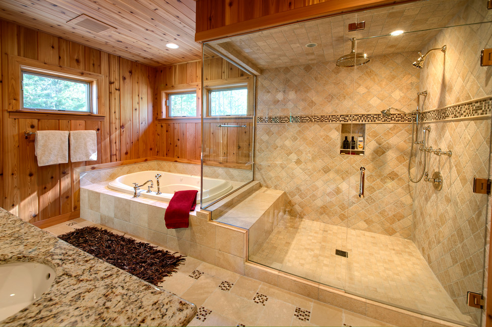 Exemple d'une grande salle de bain principale montagne avec une baignoire posée, une douche d'angle, un carrelage beige, un sol beige, du carrelage en travertin, un mur marron, un sol en travertin, un lavabo encastré, un plan de toilette en granite et une cabine de douche à porte battante.