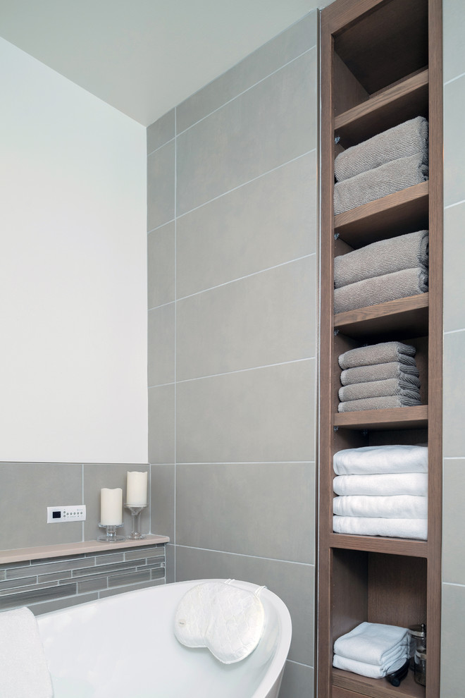 Inspiration for a medium sized modern ensuite bathroom in Other with shaker cabinets, brown cabinets, a freestanding bath, a built-in shower, a one-piece toilet, grey tiles, cement tiles, grey walls, porcelain flooring, a submerged sink and concrete worktops.