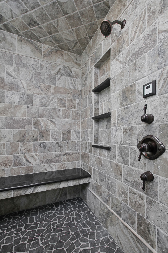 Example of a large transitional master stone tile ceramic tile bathroom design in Philadelphia with shaker cabinets, black cabinets, an undermount sink and solid surface countertops