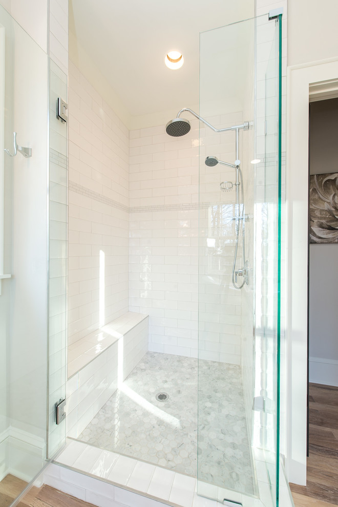 This is an example of a medium sized traditional ensuite bathroom in Charlotte with a claw-foot bath, beige walls, light hardwood flooring and beige floors.