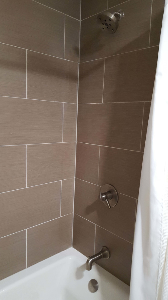 Bathroom - mid-sized modern master brown tile and ceramic tile terra-cotta tile bathroom idea in Albuquerque with flat-panel cabinets, light wood cabinets, a two-piece toilet, white walls, an undermount sink and quartz countertops