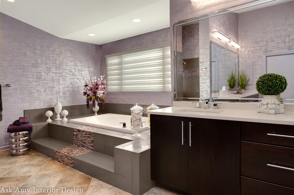 Inspiration for an expansive modern ensuite bathroom in Charlotte with flat-panel cabinets, dark wood cabinets, a built-in bath, grey tiles, purple walls, a corner shower, a one-piece toilet, ceramic flooring, a submerged sink and solid surface worktops.