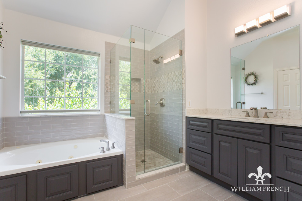 Inspiration for a mid-sized transitional master porcelain tile and brown floor bathroom remodel in Dallas with raised-panel cabinets, gray cabinets, a two-piece toilet, an undermount sink, quartz countertops, a hinged shower door, multicolored countertops and a built-in vanity