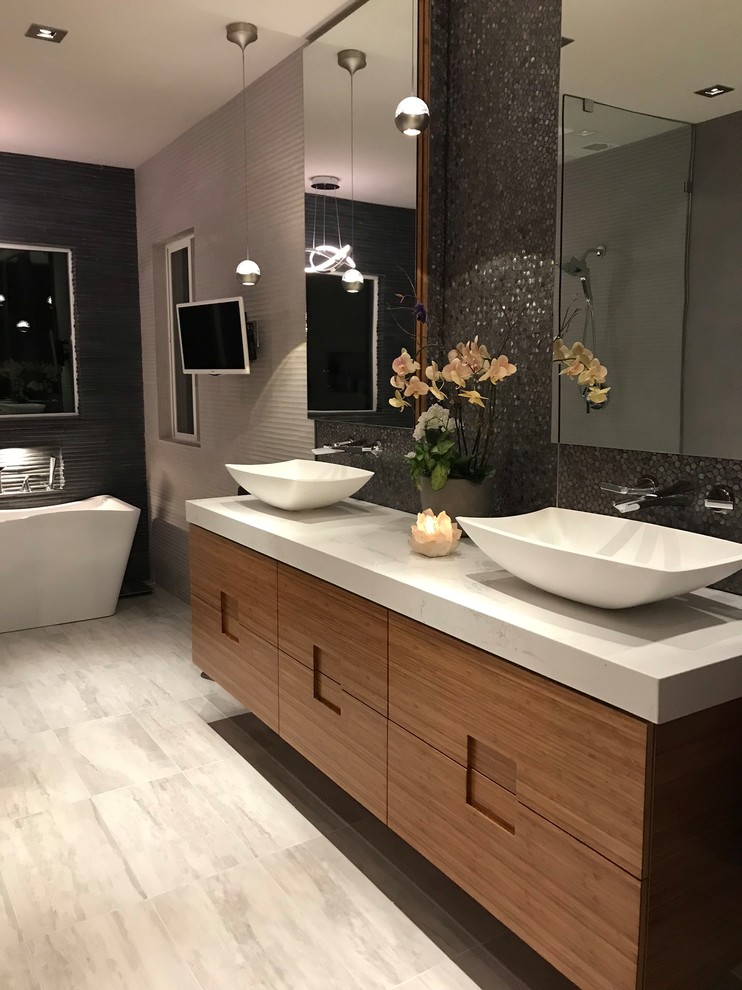 Bathroom - large modern master gray tile and stone tile porcelain tile and gray floor bathroom idea in San Francisco with flat-panel cabinets, light wood cabinets, a bidet, gray walls, a vessel sink, quartzite countertops and white countertops
