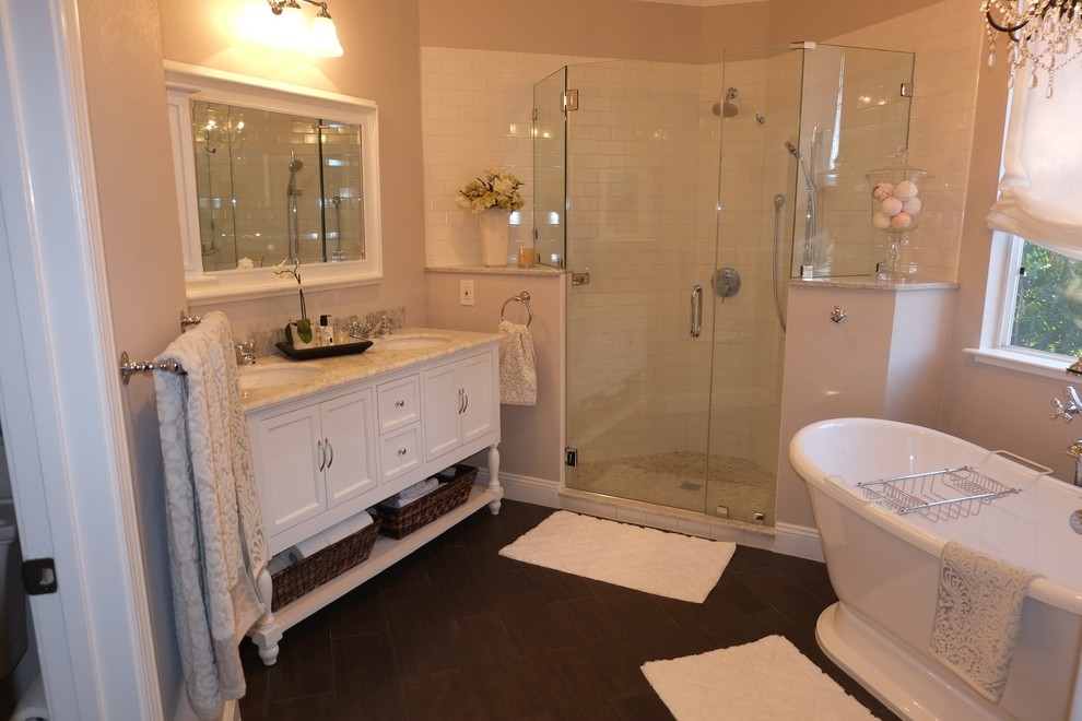 This is an example of a medium sized classic ensuite bathroom in San Francisco with a console sink, recessed-panel cabinets, white cabinets, marble worktops, a freestanding bath, a corner shower, a two-piece toilet, brown tiles, porcelain tiles, grey walls and porcelain flooring.