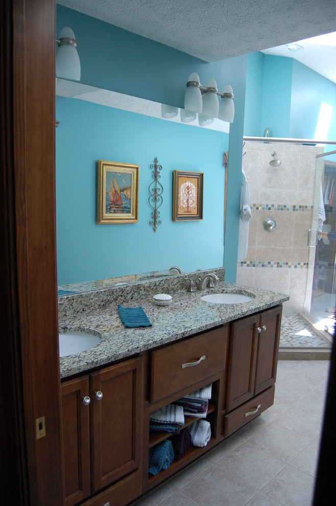 Bathroom - large contemporary master mosaic tile porcelain tile bathroom idea in Indianapolis with recessed-panel cabinets, dark wood cabinets, blue walls, an undermount sink and laminate countertops