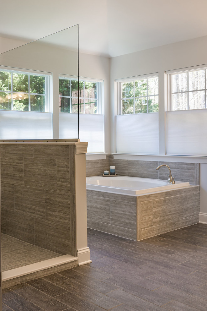 Example of a large transitional master gray tile and ceramic tile porcelain tile bathroom design in Baltimore with white cabinets, a one-piece toilet, an undermount sink, granite countertops, raised-panel cabinets and white walls