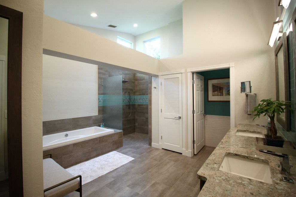 This is an example of a medium sized contemporary ensuite bathroom in Tampa with turquoise cabinets, a built-in bath, a walk-in shower, a one-piece toilet, white walls, a built-in sink, brown floors, an open shower, grey worktops, an enclosed toilet, double sinks and exposed beams.