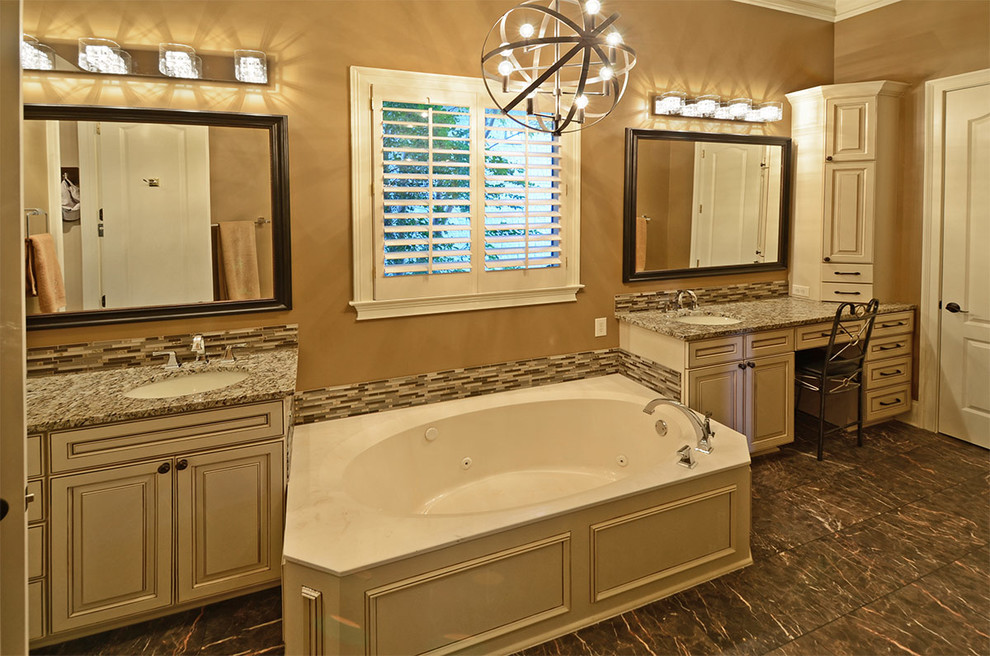 Drop-in bathtub - mid-sized traditional master multicolored tile and porcelain tile porcelain tile drop-in bathtub idea in Other with raised-panel cabinets, distressed cabinets, beige walls, an undermount sink and granite countertops