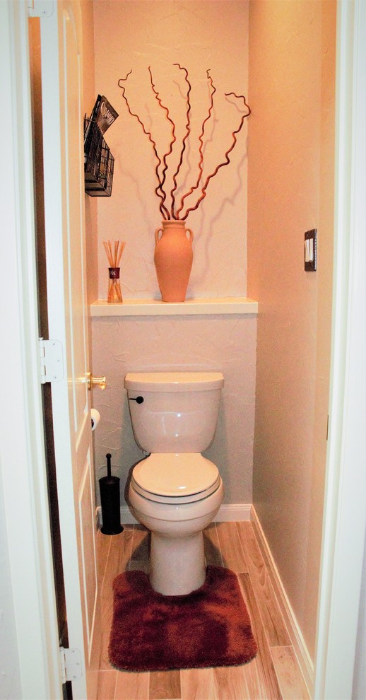 Inspiration for a large classic cloakroom in Dallas with shaker cabinets, brown cabinets, a one-piece toilet, beige tiles, ceramic tiles, beige walls, ceramic flooring, a vessel sink, granite worktops and beige floors.