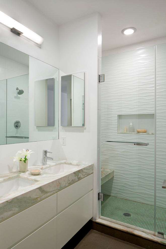Large trendy master white tile and ceramic tile mosaic tile floor and green floor alcove shower photo in New York with flat-panel cabinets, beige cabinets, a one-piece toilet, white walls, a drop-in sink, marble countertops, a hinged shower door and beige countertops