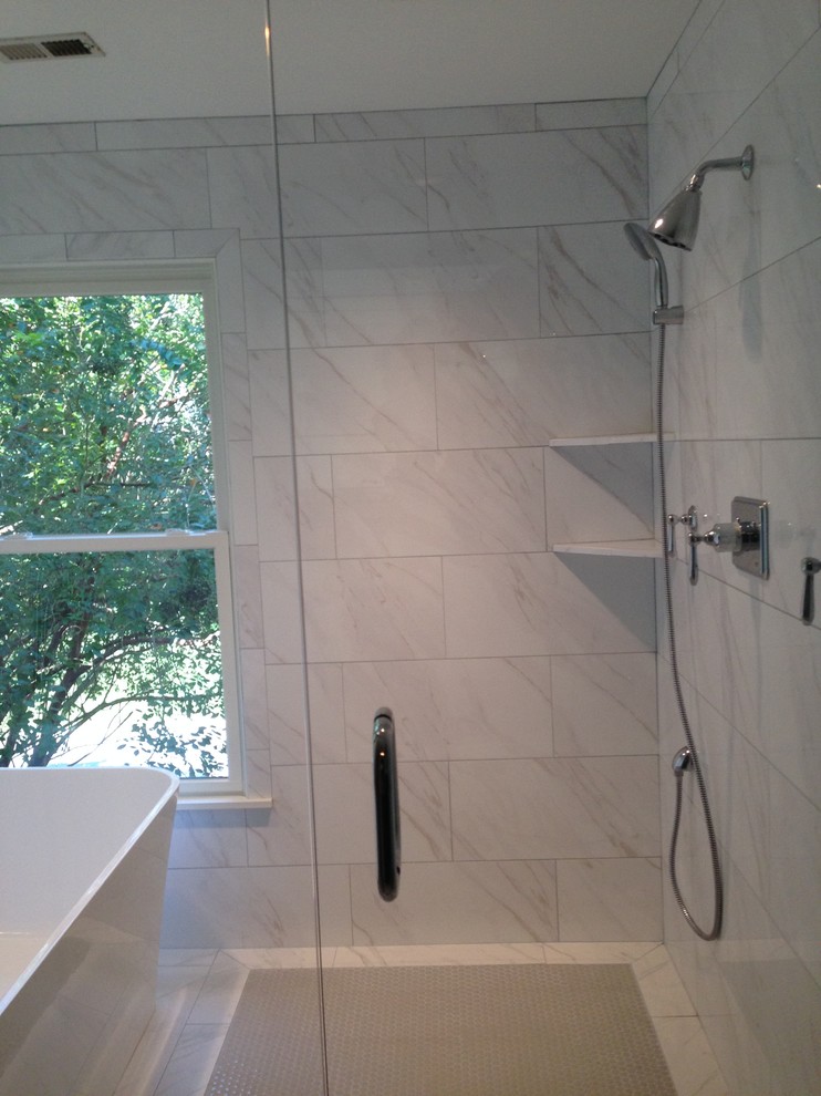 Photo of a contemporary bathroom in Birmingham with a freestanding bath, a double shower, a bidet, white tiles and metro tiles.