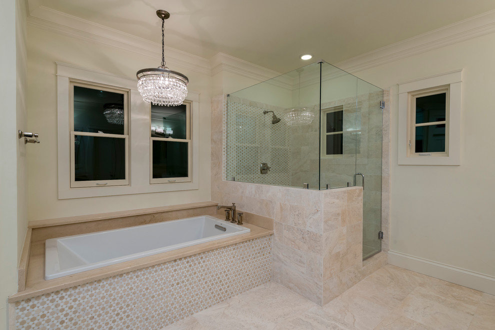This is an example of a large traditional ensuite bathroom in Austin with recessed-panel cabinets, white cabinets, an alcove bath, an alcove shower, beige tiles, stone slabs, a submerged sink, limestone worktops, beige floors, a hinged door, beige walls and marble flooring.
