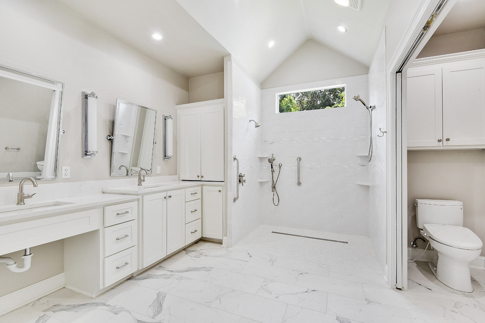 Photo of a large traditional ensuite bathroom in New Orleans with shaker cabinets, white cabinets, an alcove shower, a two-piece toilet, white tiles, metro tiles, grey walls, porcelain flooring, a submerged sink, quartz worktops, multi-coloured floors, an open shower and white worktops.