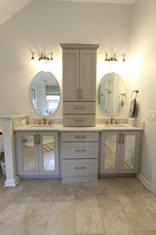 Inspiration for a mid-sized transitional master beige tile and limestone tile limestone floor and beige floor bathroom remodel in Cleveland with flat-panel cabinets, gray cabinets, a two-piece toilet, beige walls, an undermount sink, quartz countertops, a hinged shower door and beige countertops