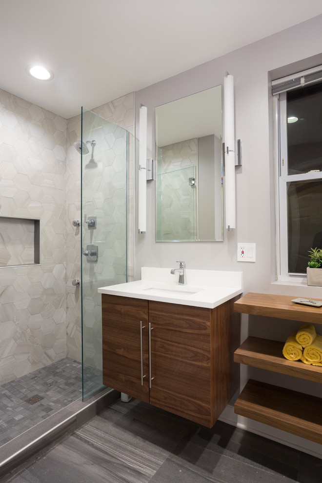 Alcove shower - mid-sized contemporary master multicolored tile and mosaic tile marble floor alcove shower idea in Chicago with flat-panel cabinets, medium tone wood cabinets, a one-piece toilet, gray walls, an undermount sink and limestone countertops