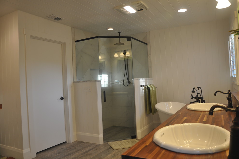 Example of a mid-sized beach style master white tile and porcelain tile porcelain tile bathroom design in Tampa with shaker cabinets, white cabinets, a two-piece toilet, white walls, a drop-in sink and wood countertops