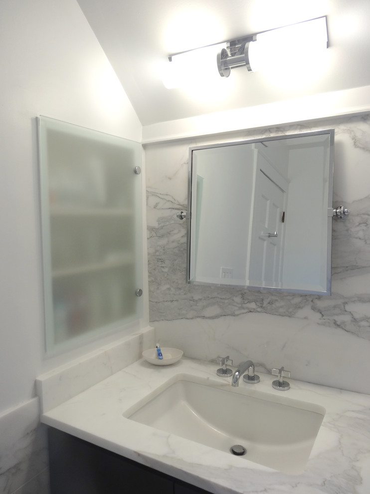 Trendy white tile and stone tile bathroom photo in Atlanta with an undermount sink, flat-panel cabinets, dark wood cabinets, marble countertops and a one-piece toilet