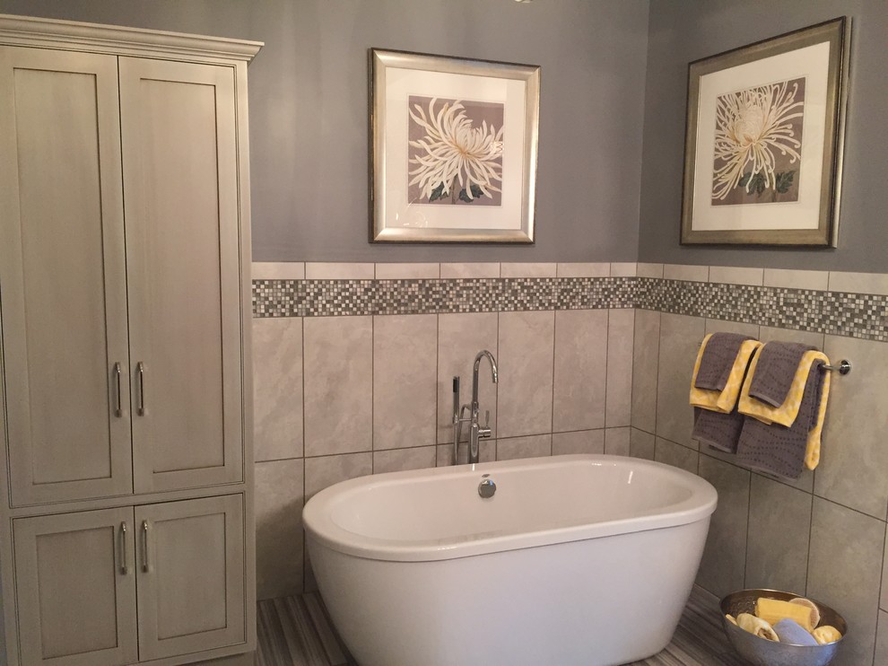 This is an example of a medium sized modern ensuite bathroom in Other with grey cabinets, a freestanding bath, grey walls, shaker cabinets, a two-piece toilet, grey tiles, mosaic tiles, ceramic flooring, a submerged sink and marble worktops.