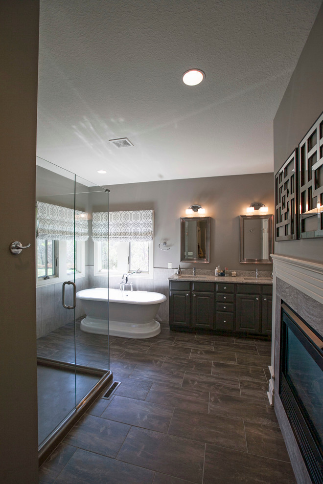 Inspiration for a timeless master gray tile and porcelain tile porcelain tile bathroom remodel in Other with an integrated sink, raised-panel cabinets, gray cabinets, solid surface countertops, a two-piece toilet and gray walls