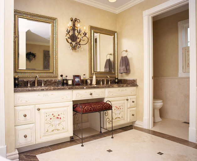 Inspiration for a large timeless master beige tile and stone tile limestone floor corner bathtub remodel in Chicago with an undermount sink, raised-panel cabinets, white cabinets, marble countertops and beige walls