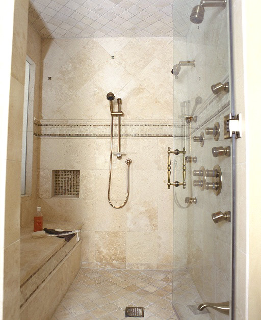 Photo of a large classic ensuite bathroom in Chicago with a submerged sink, raised-panel cabinets, white cabinets, marble worktops, a corner bath, beige tiles, stone tiles, beige walls and limestone flooring.