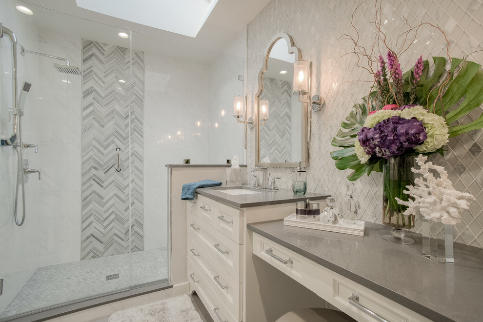 Small traditional ensuite bathroom in Dallas with shaker cabinets, white cabinets, a corner shower, a two-piece toilet, grey tiles, glass tiles, grey walls, porcelain flooring, a submerged sink, engineered stone worktops, grey floors and a hinged door.