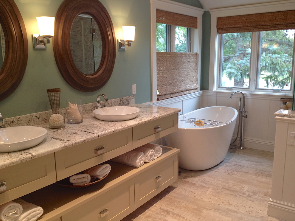 Small transitional master gray tile and marble tile gray floor bathroom photo in Detroit with shaker cabinets, beige cabinets, green walls, a vessel sink, quartzite countertops, a hinged shower door and gray countertops