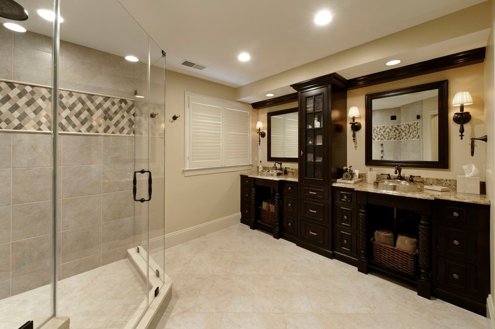 Design ideas for a medium sized traditional ensuite bathroom in DC Metro with a built-in sink, recessed-panel cabinets, dark wood cabinets, granite worktops, a corner shower, a one-piece toilet, beige tiles, stone tiles, beige walls, travertine flooring, beige floors, a hinged door and brown worktops.