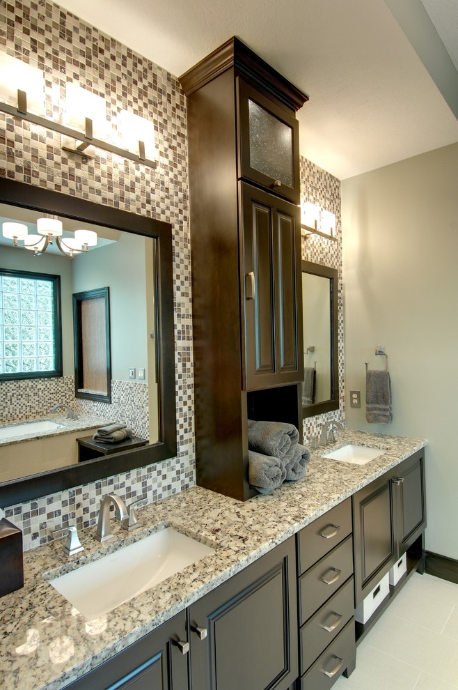 Example of a large trendy master beige tile and ceramic tile ceramic tile alcove shower design in Columbus with an undermount sink, raised-panel cabinets, granite countertops, a two-piece toilet, brown walls and dark wood cabinets