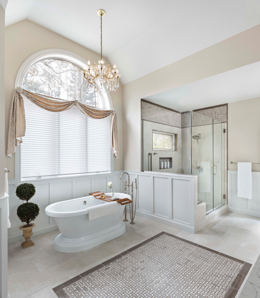 This is an example of an expansive traditional ensuite bathroom in Detroit with a freestanding bath, a corner shower, a bidet, porcelain tiles, beige walls, porcelain flooring, beige floors, a hinged door, a vaulted ceiling, wainscoting and beige tiles.