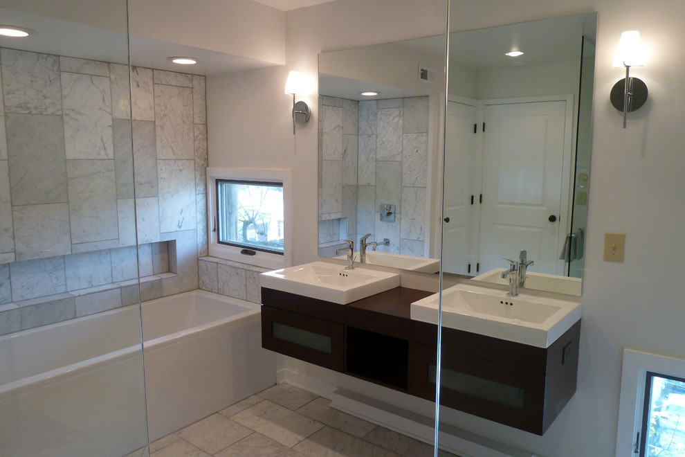 Example of a mid-sized minimalist master white tile and stone tile marble floor bathroom design in Cincinnati with a vessel sink, flat-panel cabinets, dark wood cabinets, wood countertops, a wall-mount toilet and white walls