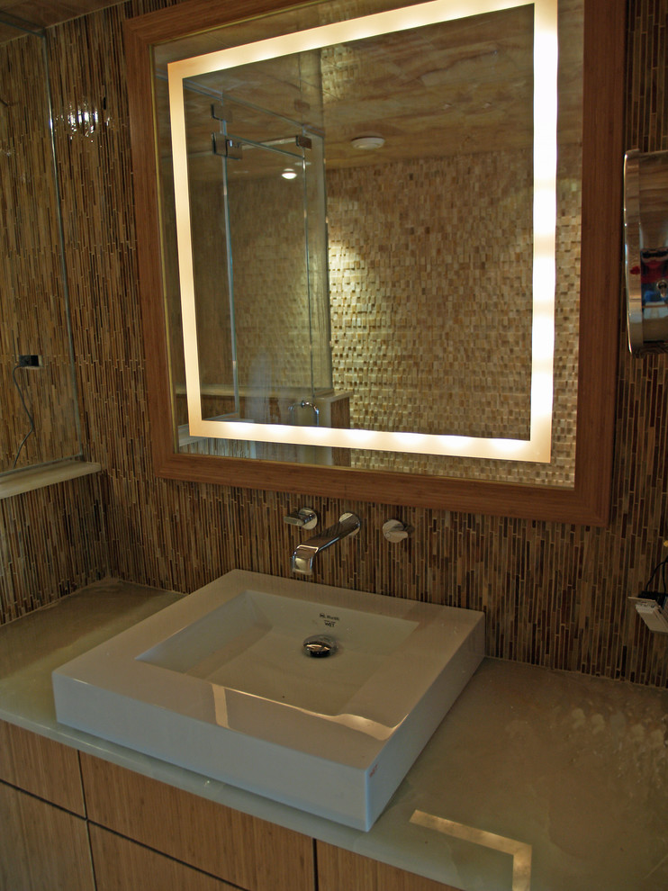 Medium sized contemporary shower room bathroom in New York with flat-panel cabinets, light wood cabinets, beige tiles, brown tiles, white tiles, a vessel sink, solid surface worktops and glass tiles.